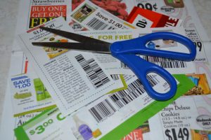 scattered coupons and pair of scissors