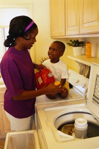 Woman putting detergent in washer