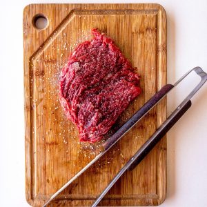 Wooden cutting board with beef cut